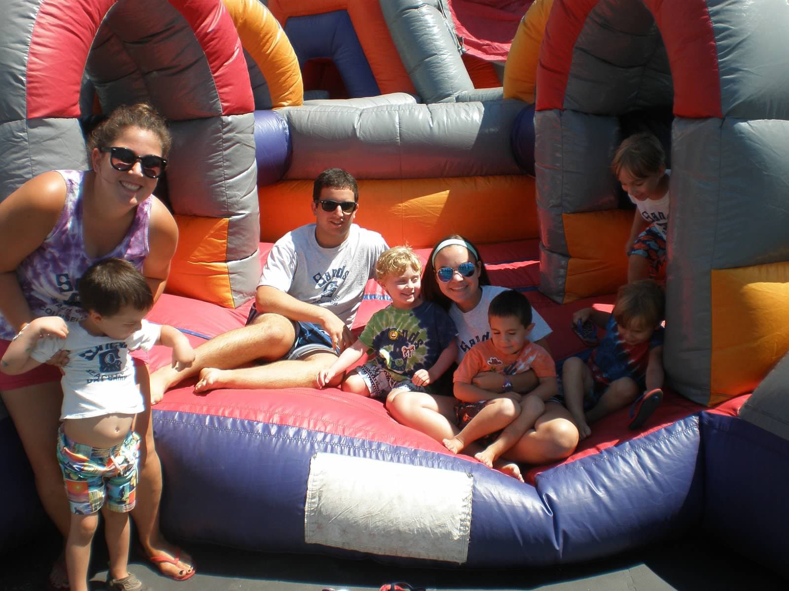 Day camp children and counselors in an inflatable play structure at The Sands